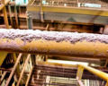 Powder dust, laying on pipes in a manufacturing company.